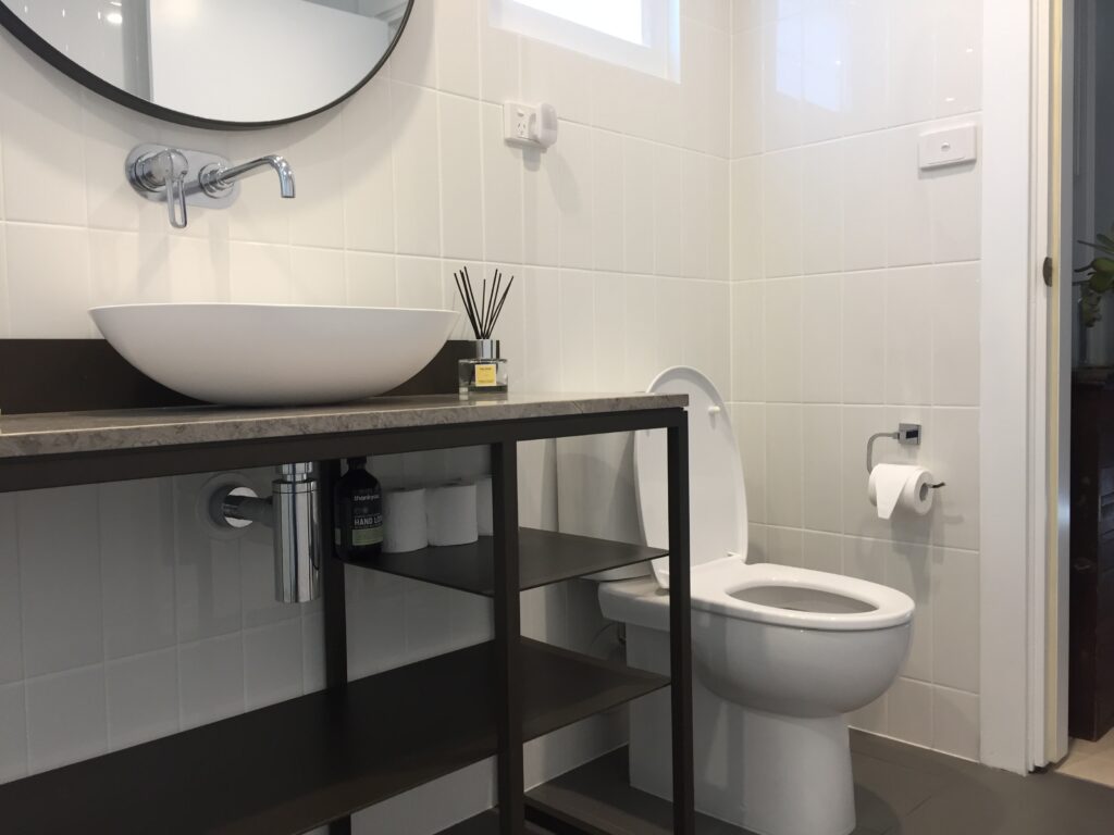 bathroom with a basin and a toilet in the corner