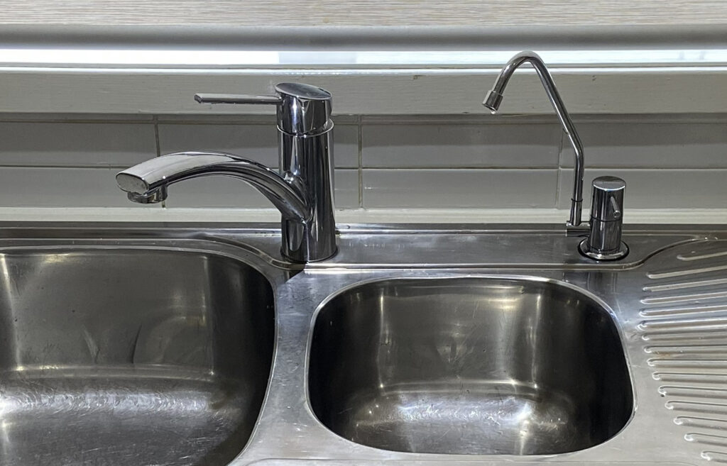 flick mixer and a filter tap above a kitchen sink