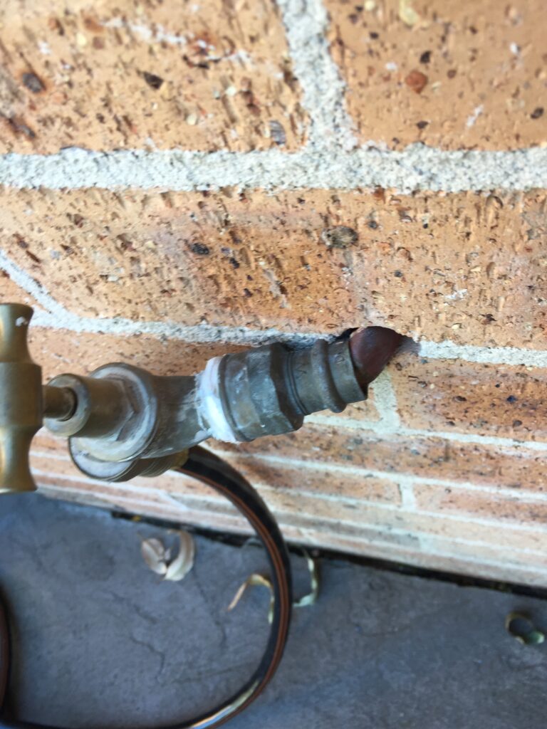 A hose cock that is bent at the wall